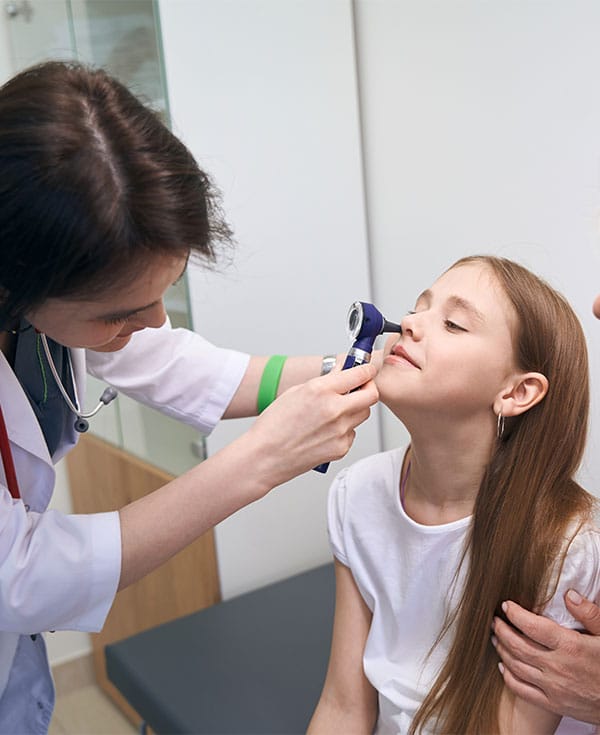 kid gettting checked by doctor