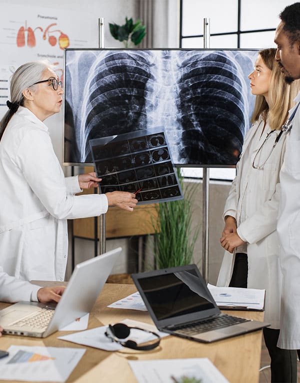 three doctors checking different x rays